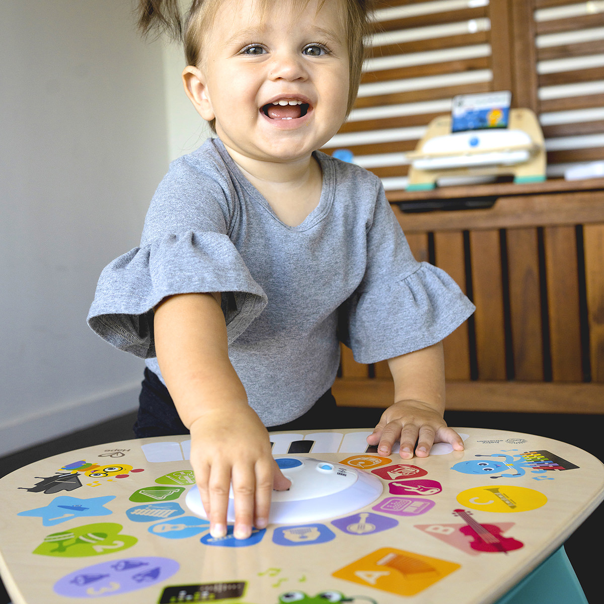 A toddler in a playroom filled with children's musical toys