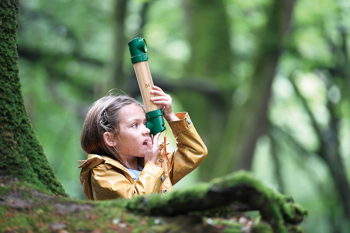 A child playing with the hide-and-seek periscope, one of the best outdoor children's toys for encouraging a love of nature.